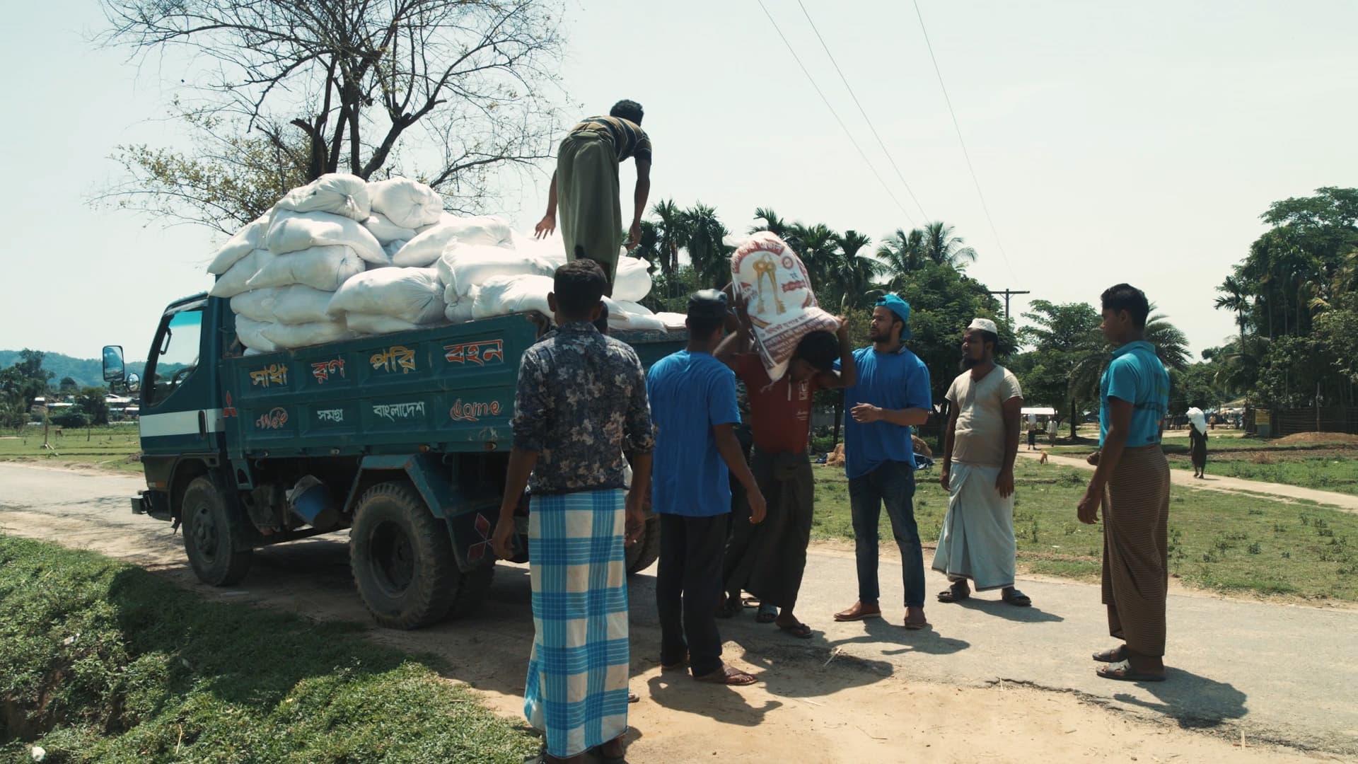 Sacks of aid being unloaded from a truck