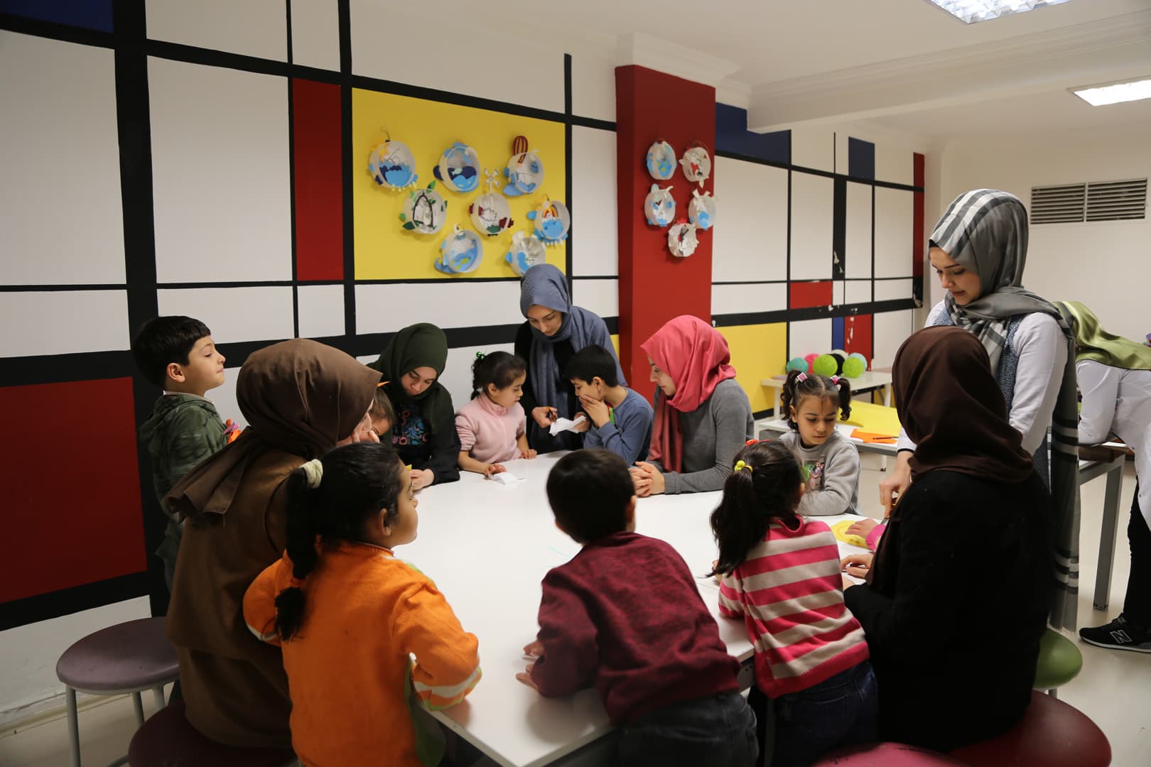 Children and teachers around a classroom table