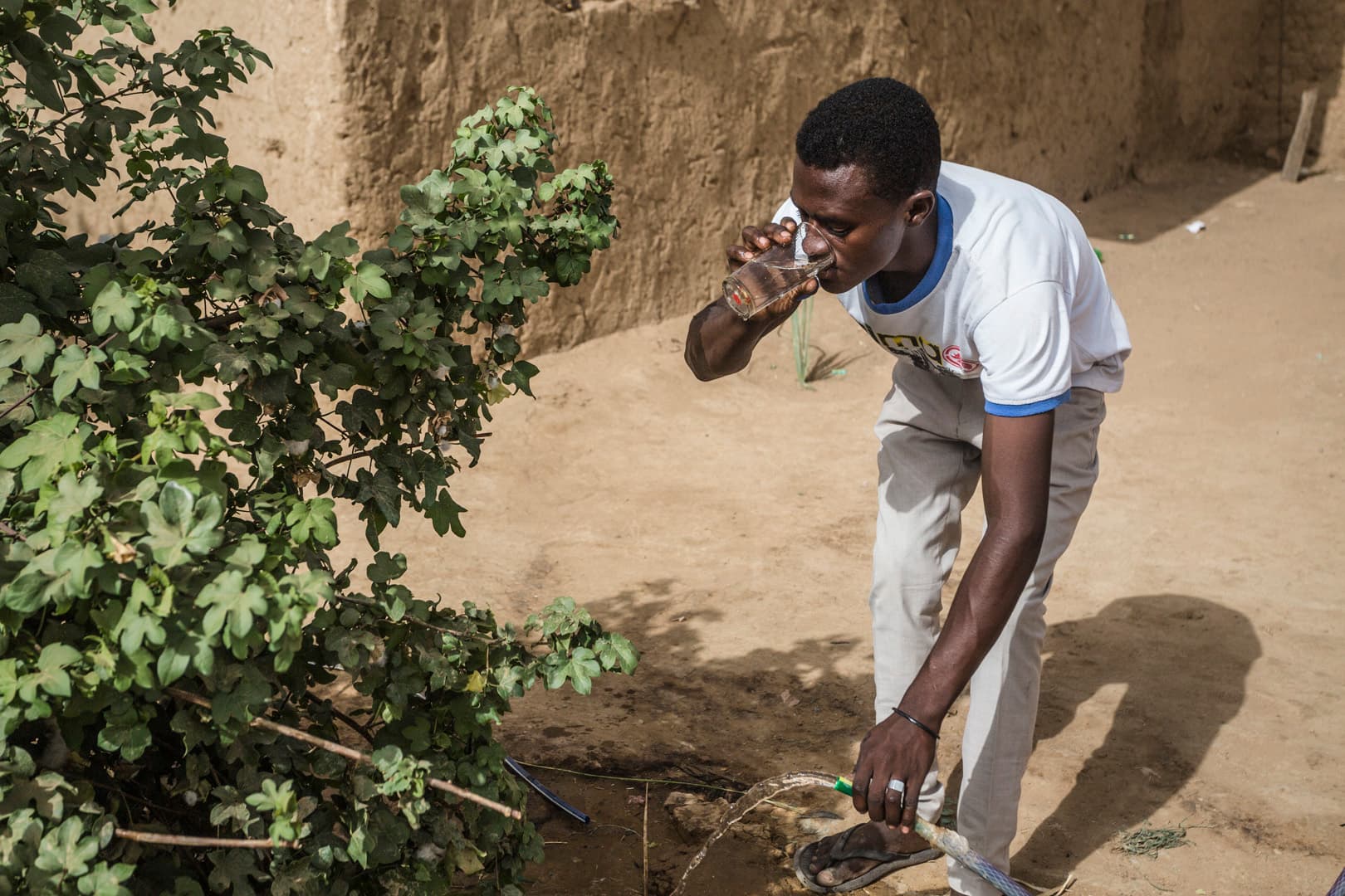 A man drinking clean water from a tap