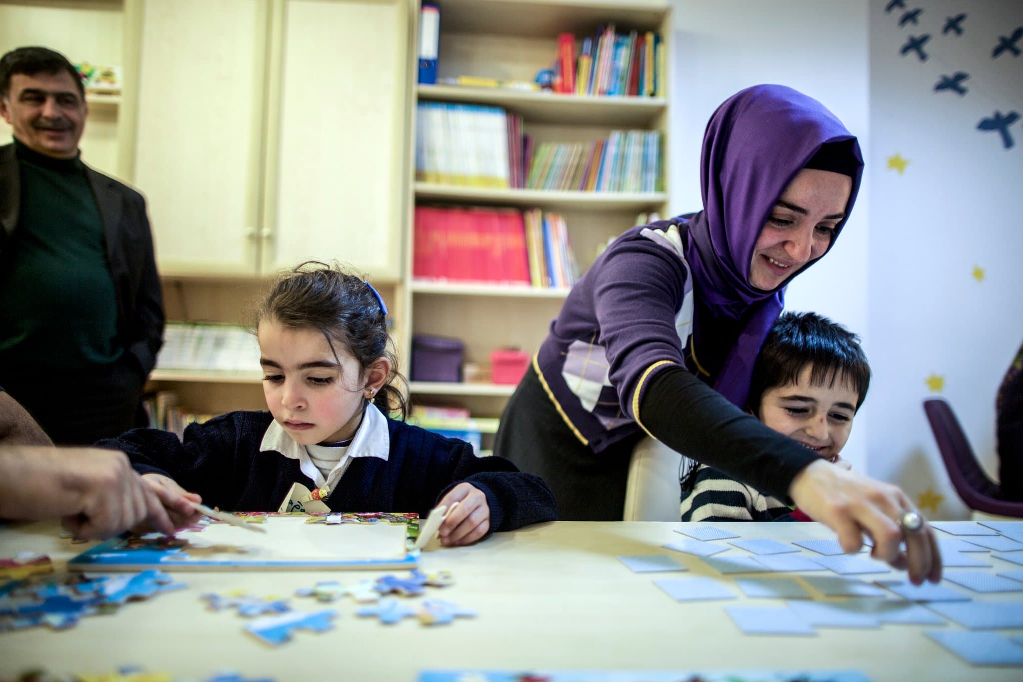 A teacher and children doing a puzzle in class